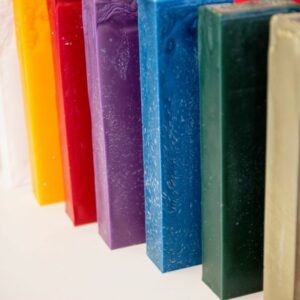 Sticks of bottle sealing wax displayed in a wide variety of colors: green, blue, purple, etc.