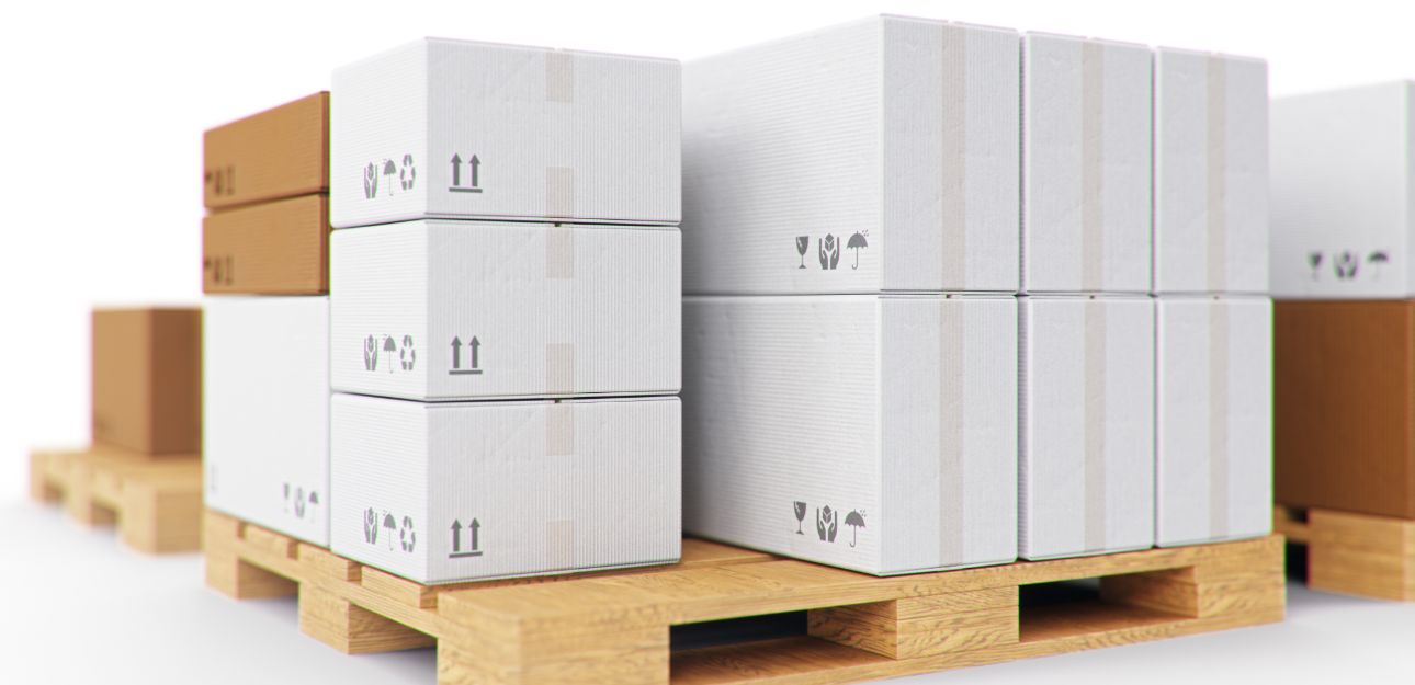 White and brown cardboard boxes piled on a wooden pallet. 